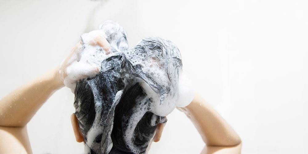 lady-using-shampoo-wash-clean-her-hair-bathroom-with-splash-shower-spray-water